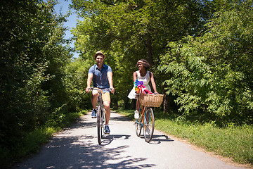 Image showing Young multiethnic couple having a bike ride in nature