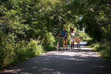 Image showing Young multiethnic couple having a bike ride in nature