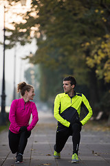 Image showing a young couple warming up before jogging