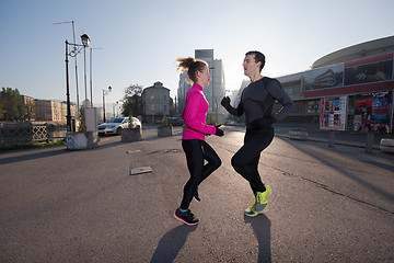 Image showing couple warming up before jogging