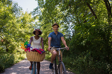 Image showing Young multiethnic couple having a bike ride in nature