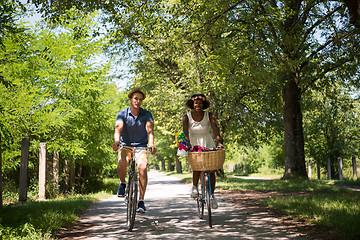 Image showing Young multiethnic couple having a bike ride in nature