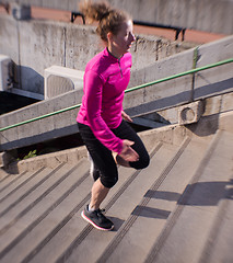 Image showing woman jogging on  steps