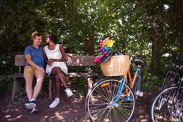 Image showing Young multiethnic couple having a bike ride in nature