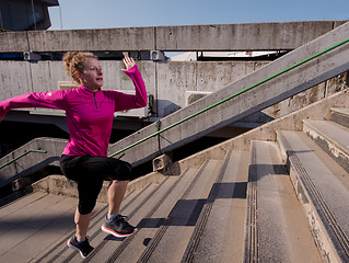 Image showing woman jogging on  steps