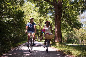 Image showing Young multiethnic couple having a bike ride in nature