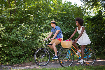 Image showing Young multiethnic couple having a bike ride in nature