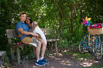 Image showing Young multiethnic couple having a bike ride in nature