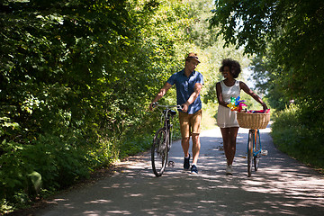 Image showing Young multiethnic couple having a bike ride in nature