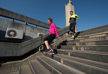 Image showing young  couple jogging on steps