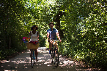 Image showing Young multiethnic couple having a bike ride in nature