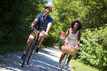 Image showing Young multiethnic couple having a bike ride in nature