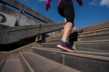 Image showing woman jogging on  steps