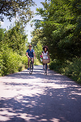 Image showing Young multiethnic couple having a bike ride in nature