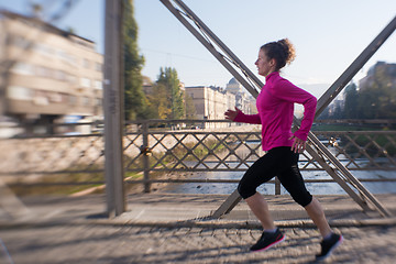 Image showing sporty woman jogging on morning