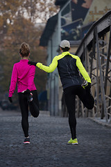 Image showing couple warming up before jogging