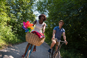 Image showing Young multiethnic couple having a bike ride in nature