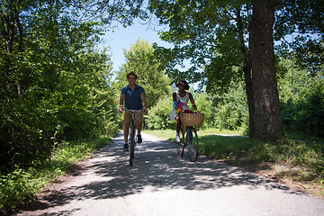 Image showing Young multiethnic couple having a bike ride in nature