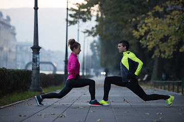 Image showing a young couple warming up before jogging