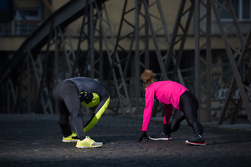 Image showing couple warming up before jogging