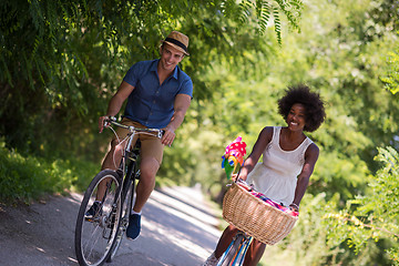 Image showing Young multiethnic couple having a bike ride in nature