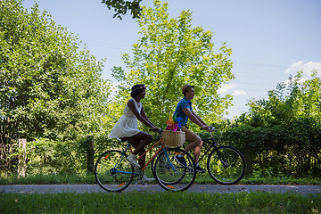 Image showing Young multiethnic couple having a bike ride in nature