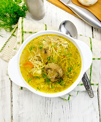 Image showing Soup with champignons and noodles in bowl on light board top