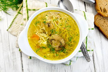 Image showing Soup with champignons and noodles in bowl on board top