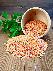 Image showing Lentils red in wooden bowl with parsley on board