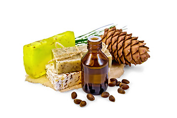 Image showing Oil and soap different with cedar nuts and cone