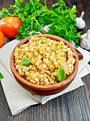 Image showing Barley porridge with tomatoes on napkin