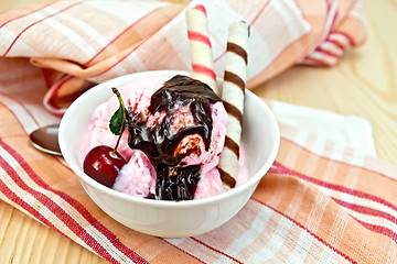 Image showing Ice cream cherry with chocolate syrup and waffles