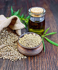 Image showing Flour hemp in bowl with oil on dark board