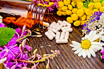 Image showing Capsules in open brown jar on board