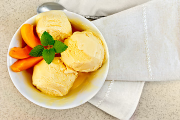 Image showing Ice cream apricot in white bowl on table top