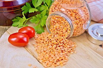 Image showing Lentils red in glass jar with tomatoes on board