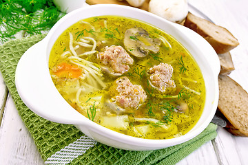 Image showing Soup with meatballs and noodles in bowl on green napkin