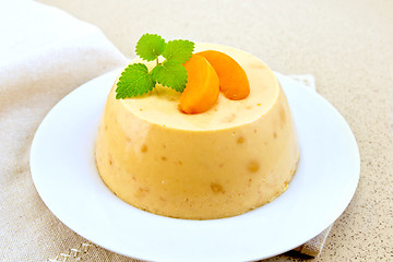 Image showing Panna cotta apricot with mint on table