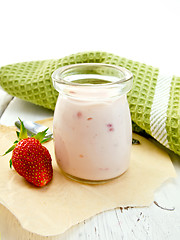 Image showing Yogurt with strawberries in jar on light board