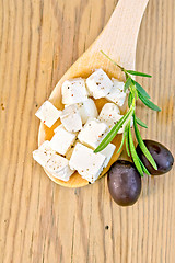 Image showing Feta with olives in spoon on board