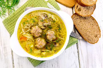 Image showing Soup with meatballs and noodles in bowl on napkin top