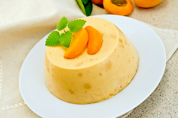 Image showing Panna cotta apricot with mint on napkin