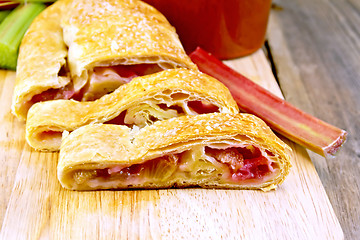 Image showing Strudel with rhubarb and mug on wooden board