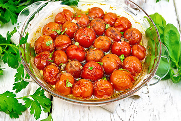 Image showing Tomatoes baked in pan on board