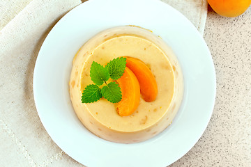 Image showing Panna cotta apricot with mint on napkin top