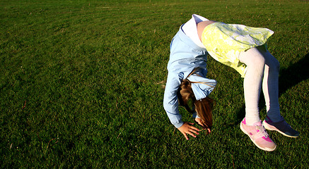 Image showing Girl doing somersault