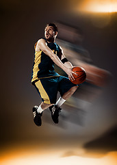 Image showing Full length portrait of a basketball player with ball