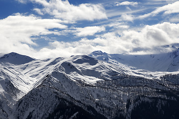 Image showing View on snow mountains and cloudy sky in sun evening