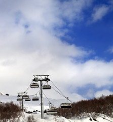 Image showing Chair lift on ski resort and snow winter mountain in clouds