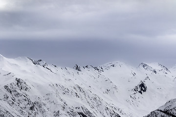 Image showing High snowy mountains and gray storm sky before blizzard